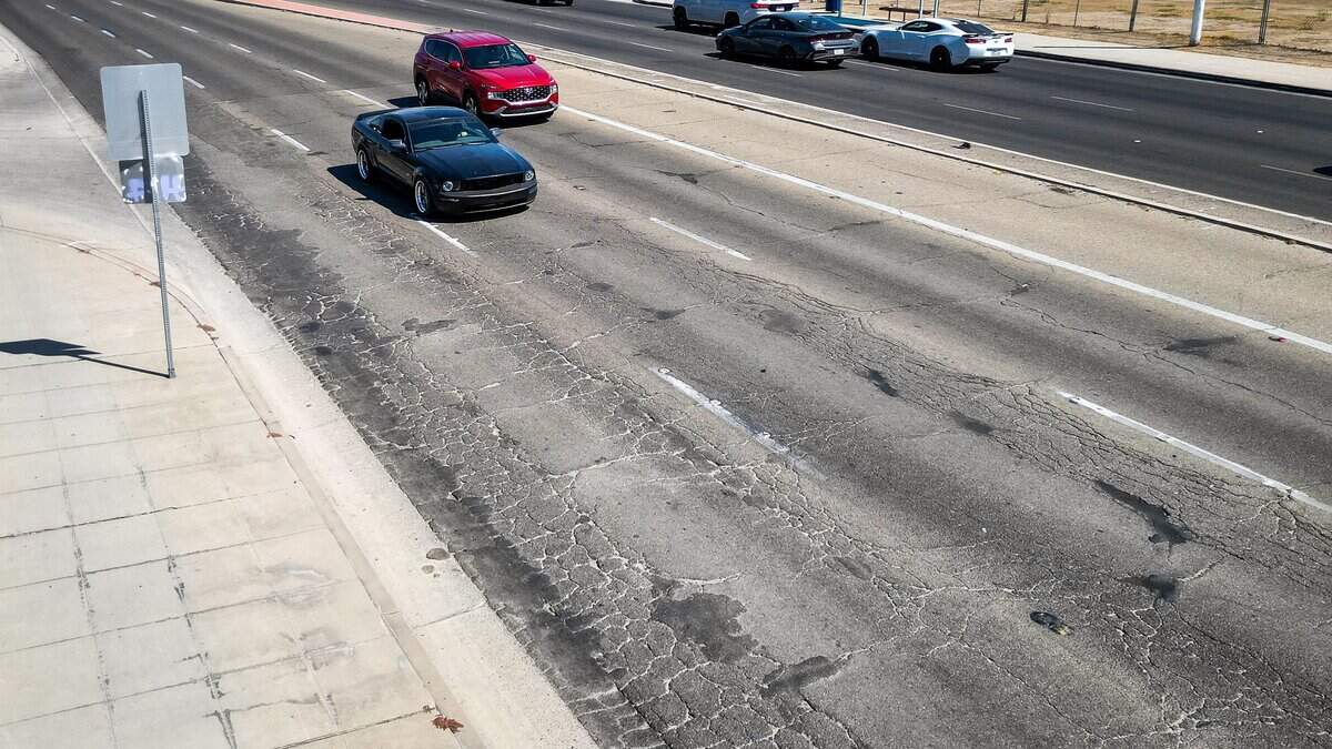 Cracked pavement appears in the roadway on West Shaw Avenue west of Blackstone Avenue in Fresno. West Shaw Avenue, particularly around Fig Garden Village, was voted to be in the most need of improvement in a poll published by The Fresno Bee.