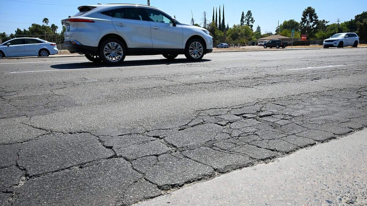 Cracked pavement appears in the roadway on West Shaw Avenue west of Blackstone Avenue in Fresno. West Shaw Avenue, particularly around Fig Garden Village, was voted to be in the most need of improvement in a poll published by The Fresno Bee.