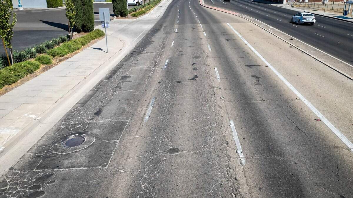 Cracked pavement appears in the roadway on West Shaw Avenue west of Blackstone Avenue in Fresno. West Shaw Avenue, particularly around Fig Garden Village, was voted to be in the most need of improvement in a poll published by The Fresno Bee.