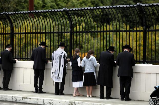 Followers of Jewish faith pray over Roaring Brook celebrating the Rosh Hashanah holiday.