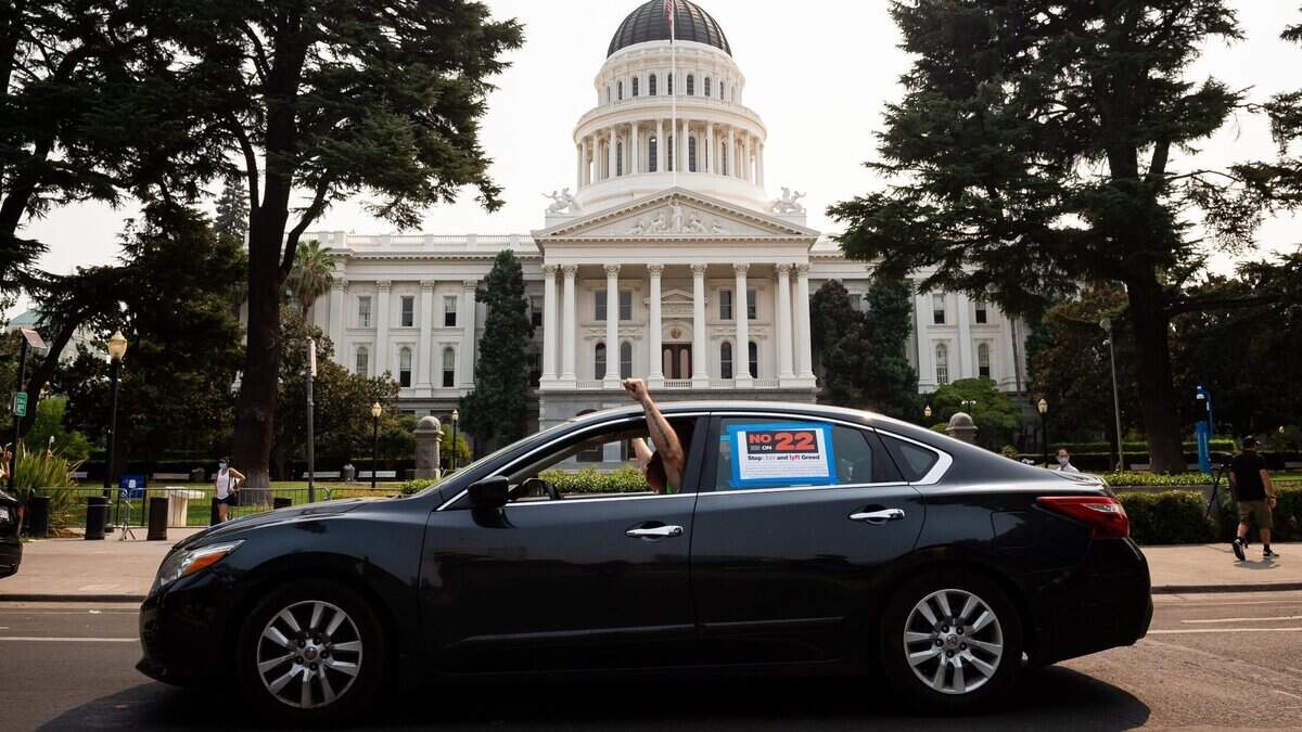 California rideshare drivers, local elected officials and labor leaders arrive in a caravan from West Sacramento at the Capitol on Labor Day Monday, Sept. 7, 2020, for a “No on Prop. 22” rally in Sacramento.