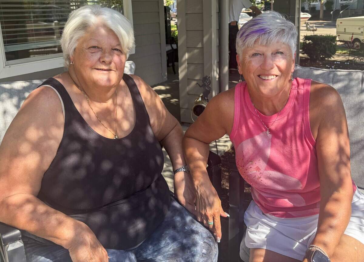 Sisters Deborah Smith, left and Tamara Welch sit together at Smith's home in Springfield, Oregon, in August. The fraternal twins stayed with the future Dorothea Puente, who falsely claimed to have adopted them, in 1963.