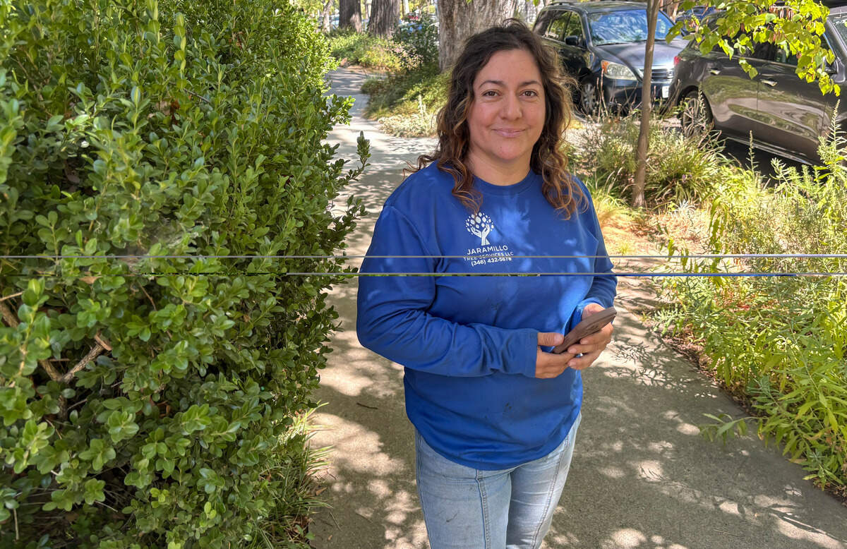 Ana Ochoa of Jaramillo Tree Services, which helped rescue a cat stranded high in a cypress in Sacramento’s Boulevard Park neighborhood, on Saturday.
