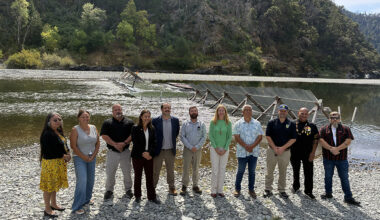 People standing next to river. CDFW photo