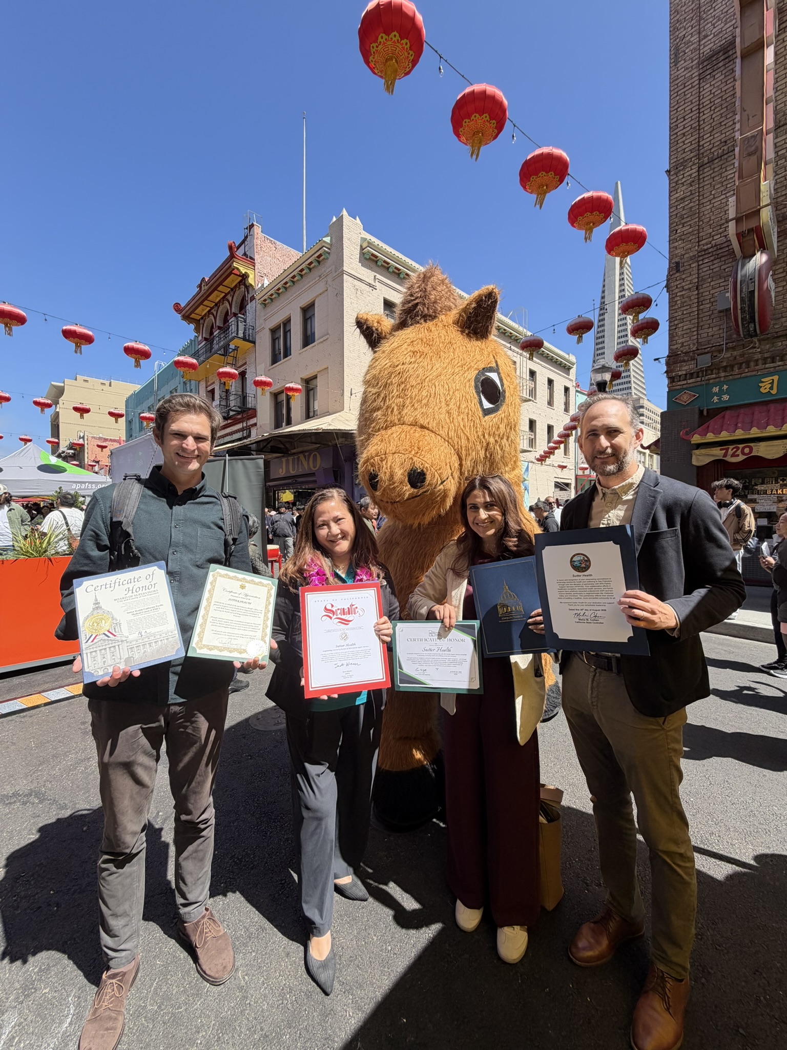 Group stands together holding certificates 