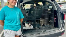 Malia Lamaku stands with her pets safe in the family car. She evacuated with her mother and sister, Sunday, to Vista High School, Vista, Calif., September 6, 2026.