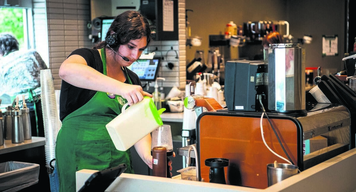 Stefanie Sharp makes a drink while working at Starbucks on Wednesday, June 29, 2023.