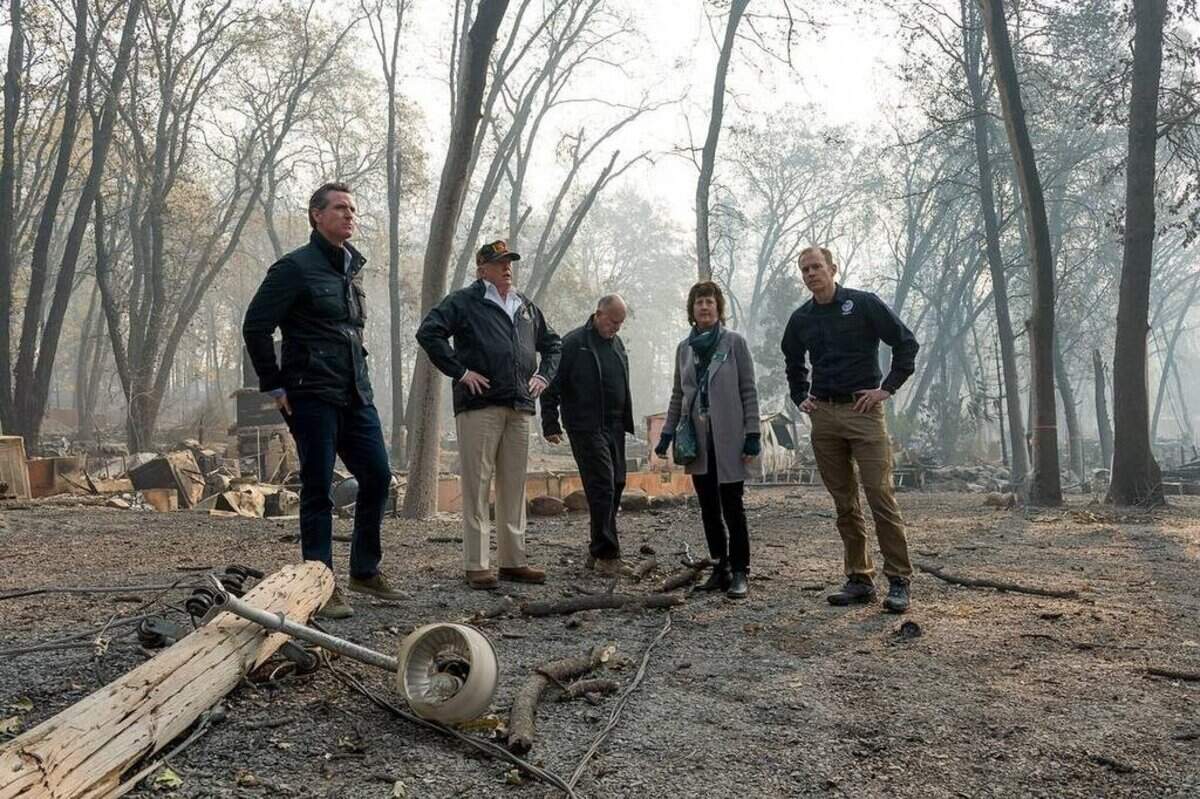 From left, then Gov.-elect Gavin Newsom, President Donald Trump, Gov. Jerry Brown,  Paradise Mayor Jody Jones and FEMA Director Brock Long tour the Skyway Villa Mobile Home and RV Park during Trump's visit to the site of the Camp Fire in Paradise on Nov. 17, 2019.