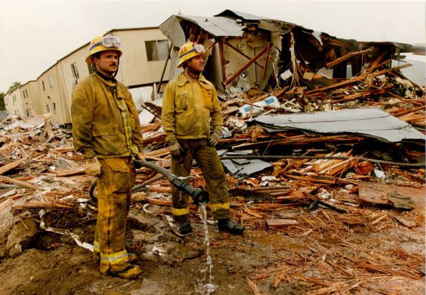 FILE -- Firefighters look over the rubble that was at one time the Northridge Meadows three-story apartment complex following the Northridge earthquake in 1994. (Photo by John McCoy, Los Angeles Daily News/SCNG)