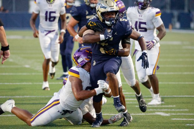 St. John Bosco's Maliq Allen (5) tries to break free close to the goaline in Bellflower, CA, on Friday, August 28, 2026. (Photo by Tracey Roman, Contributing Photographer)