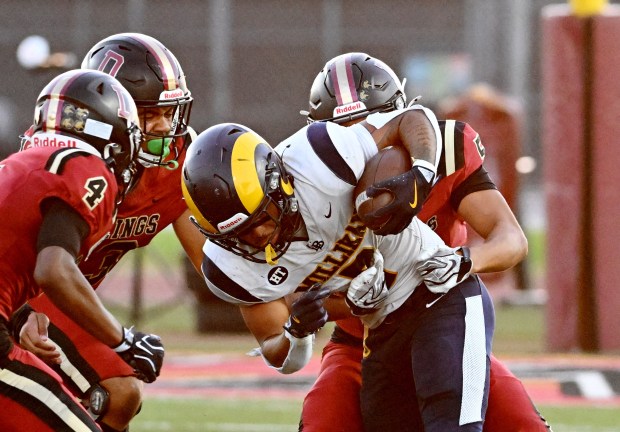 Millikan's Ryan Carter (7) is tackled by Downey Vikings Mathew Dalhover (5) as he gets a first down in the first half of a prep football game at Downey High School in Downey on Friday, September 4, 2026. (Photo by Libby Cline Birmingham, Contributing Photographer)