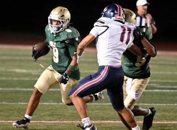 Long Beach Poly's Jeron Johnson II (9) carries against Yorba Linda in a non-league game at Veterans Stadium in Long Beach on Friday August 28, 2026. (Photo by Axel Koester, Contributing Photographer)