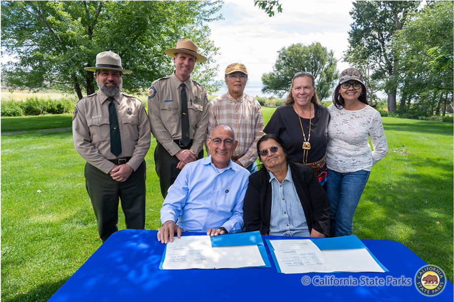 Back row left to Right: California State Parks Northern Division Chief Greg Martin, State Parks Sierra District Superintendent Rich Adams, Tribal Elder Dean Tonenna, Vice Chair Angela Eddy, and Tribal Secretary Barbara Coons. Front row left to right: State Parks Director Armando Quintero and Kootzaduka’a Tribal Chair Charlotte Lange.
