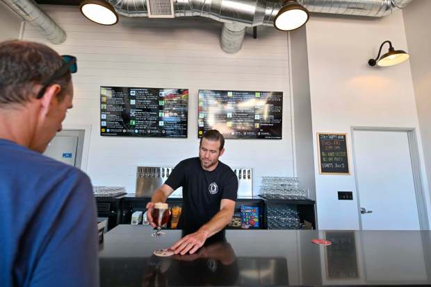 Christian Goodman serves up a beer at Dana Point Ale House in Dana Point on Wednesday, July 12, 2023. (Photo by Jeff Gritchen, Orange County Register/SCNG)