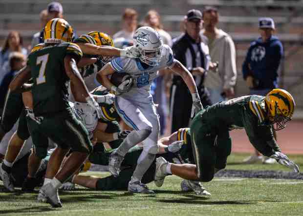 Corona del Mar wide receiver Nolan Scott (8) breaks multiple tackles as he powers his way to the 2-yard-line, leading to a touchdown on the following play, during a nonleague game against Edison in Huntington Beach on Thursday, September 3, 2026. (Photo by Jeff Antenore, Orange County Register/SCNG)