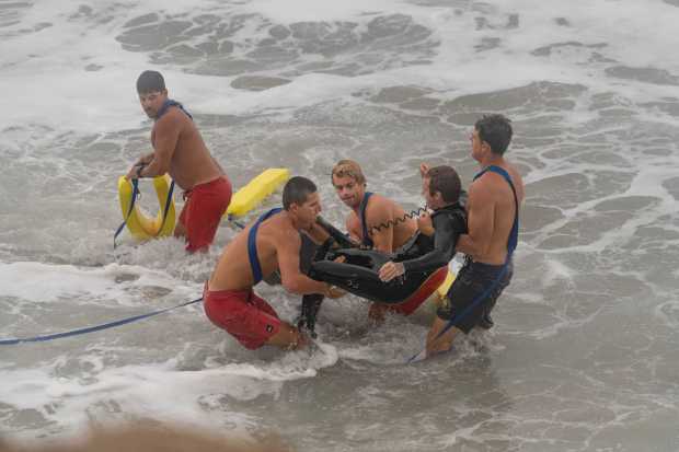 Newport Beach Ocean lifeguards carry bodyboarder Art Rodriguez out of the surf near The Wedge in Newport Beach on September 7, 2026. (Photo by Logan Graham via @logangrahamphoto)