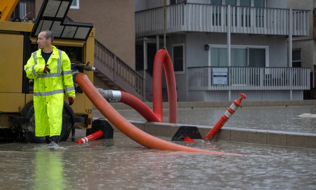Seal Beach city workers pump flood water away from homes and toward the ocean near the Pier on Sunday, September 6, 2026. (Photo by Mindy Schauer, Orange County Register/SCNG)