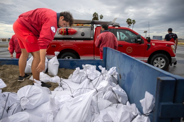 Lifeguards with the Long Beach Fire Department prepare sandbags at Granada Beach for residents in anticipation of flooding on Sunday, September 6, 2026. (Photo by Mindy Schauer, Orange County Register/SCNG)