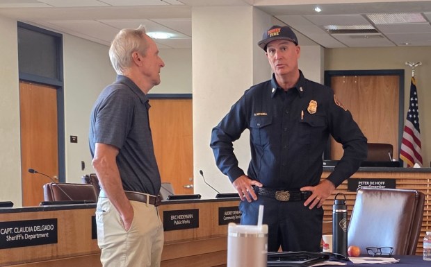 Poway Fire Chief Brian Mitchell, right, talks to a Zone Zero Defensible Space Workshop attendee before the hour-and-a-half presentation. (Julie Gallant)