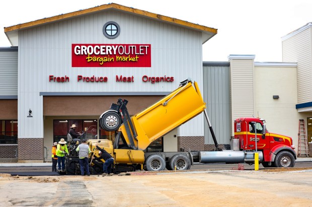 Construction crews began laying new pavement along the storefronts at Ramona Station on May 15, as renovation work continues at the former Kmart shopping center. (Stephanie Ogilvie)