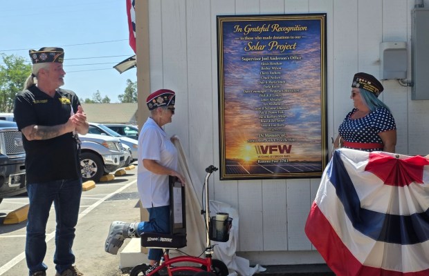 VFW Post 3783 officials unveil a plaque that contains the name of donors to a project that upgraded the post with improvements. From left are Ramona VFW Commander Todd Greenwood, former Ramona VFW Commander Karen Welch and Ramona VFW member Alexis Henshaw. (Julie Gallant)