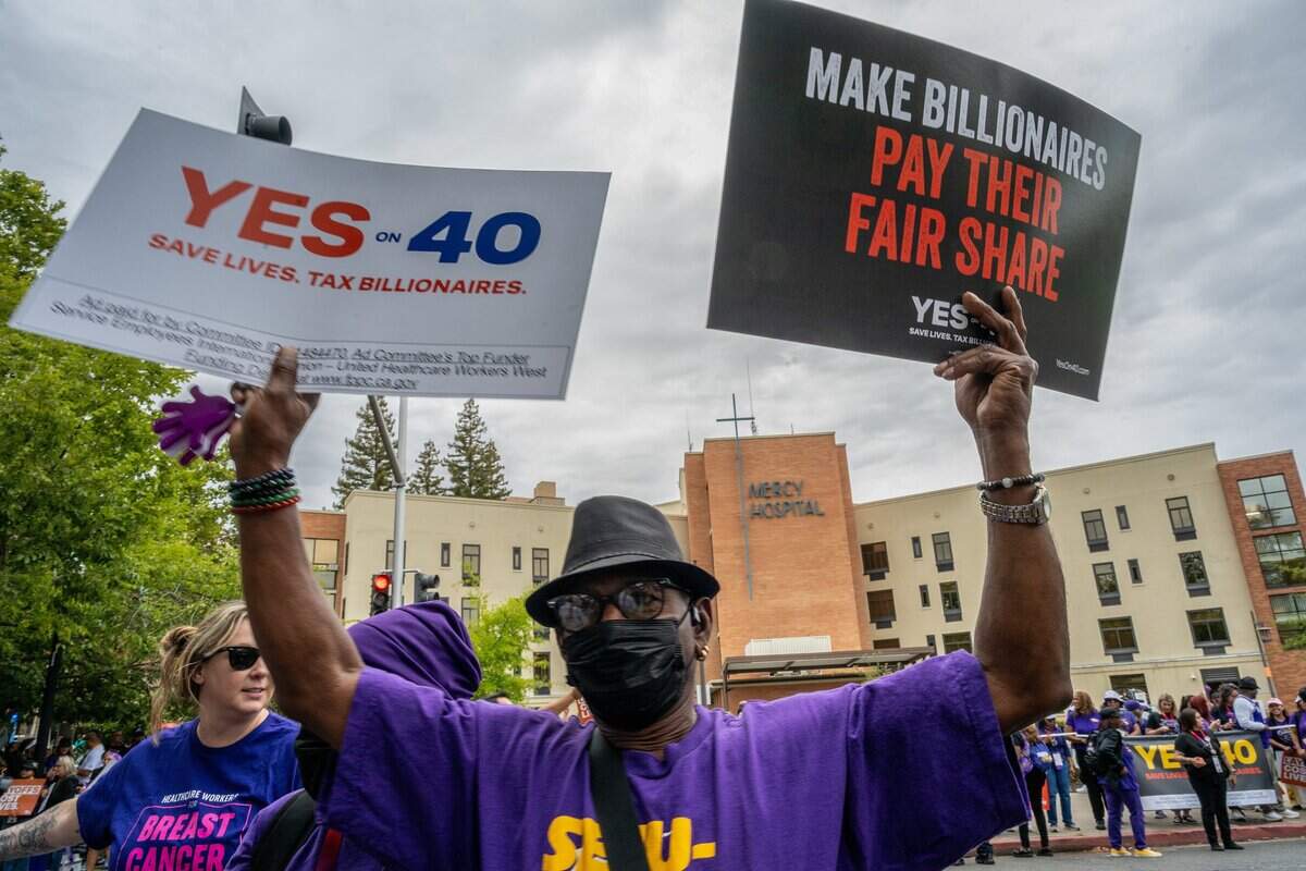 Philip Daniels joins hundreds of frontline healthcare workers from across California in a rally outside Dignity Health Mercy General Hospital on Friday, Aug. 28, to support Proposition 40, which would levy a one-time tax on California billionaires.