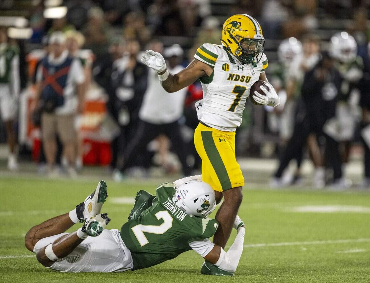 North Dakota State Bison cornerback Chance Tucker breaks away from Sacramento State Hornets cornerback Dionte Thornton for a touchdown in the first half Saturday in Sacramento.