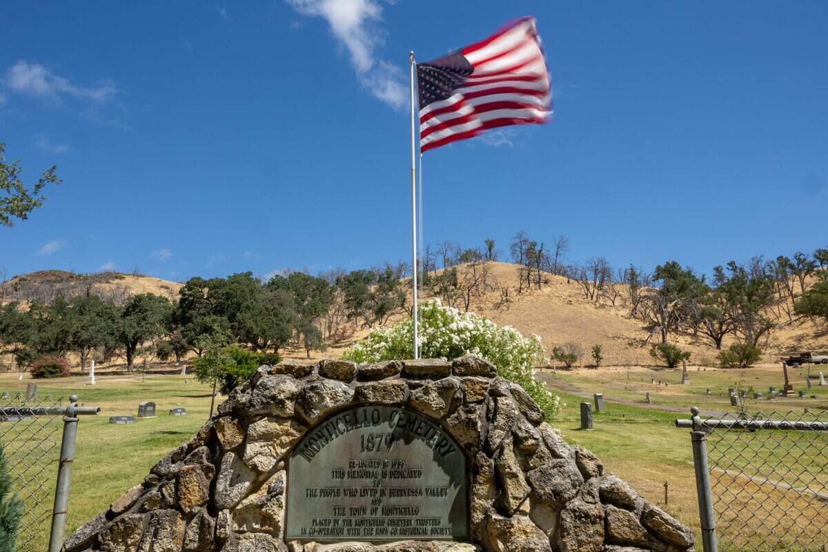 Gravestones from the original Monticello town cemetery, relocated during construction of the Monticello Dam and Lake Berryessa in the 1950s, stand at the Monticello Public Cemetery in Spanish Flat.