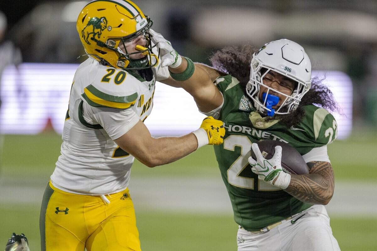Sacramento State Hornets running back Isaiah Ene pushes past North Dakota State Bison safety Hudson Artz for extra yards in the first half on Saturday in Sacramento.