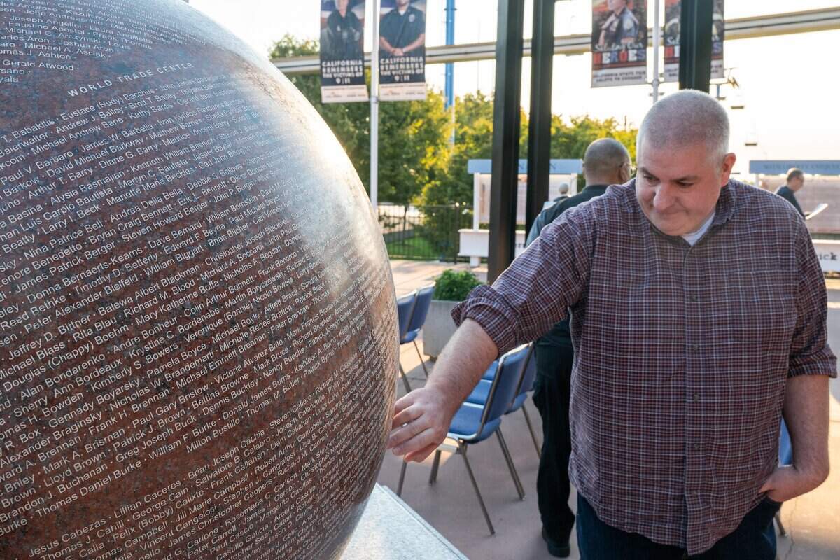 Event participant Paul looks at the names of those killed during the 9/11 attacks during the 25th anniversary memorial event at Cal Expo in Sacramento on Friday, Sept. 11, 2026.
