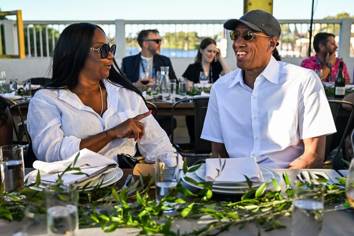 Sacramento Kings head coach Doug Christie, right, talks with his wife Jackie Christie during the Tower Bridge dinner in Sacramento on Sunday.