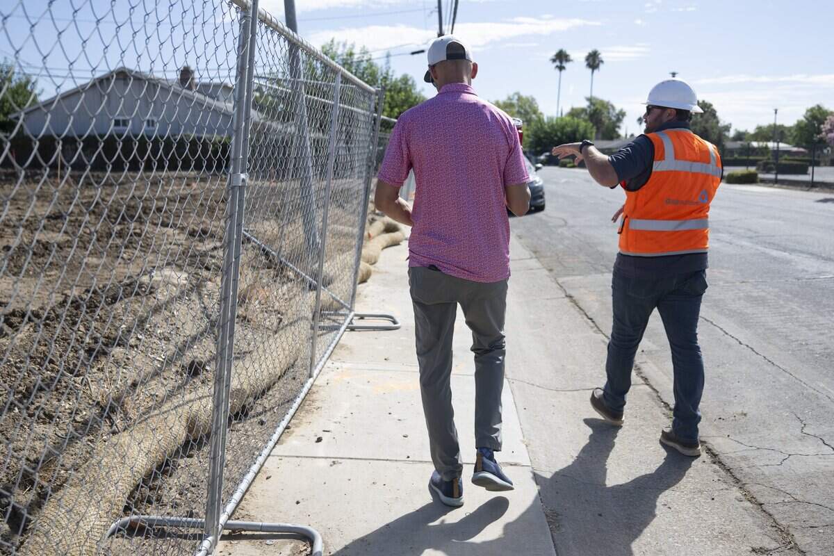 Sacramento Mayor Kevin McCarty walks along the side of the future Gardendale Road micro-community for Sacramento homeless seniors with G&G Builders Superintendent Keith Lucas on Thursday, Aug. 27, 2026. Thirty tiny homes are planned for the site.
