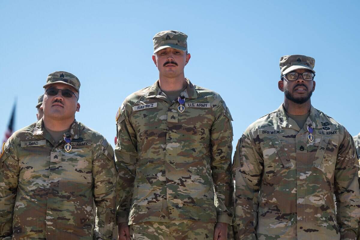U.S. Army Spc. Chuehue Thao, left, Sgt. Andrew Ramirez, center, and Staff Sgt. Shawn Brewer of the 319th Expeditionary Signal Battalion await commands after receiving Purple Heart medals during a soldiers homecoming ceremony at B.T. Collins U.S Army Reserve Center in Sacramento on Saturday.