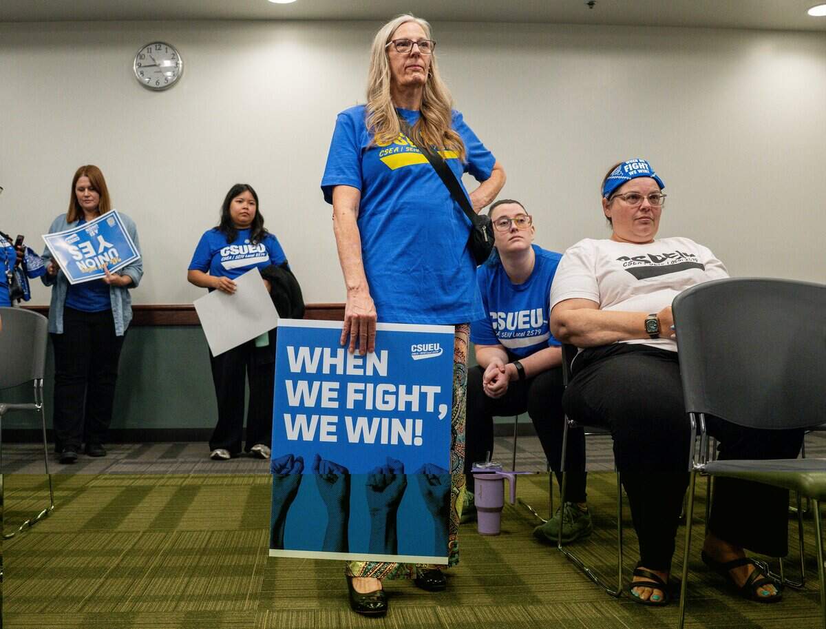 A member of California State University Employees Union holds a sign during a group meeting following a bargaining session between the union and the California State University system at Sac State Student Union in Sacramento on Wednesday, Sept. 2, 2026.