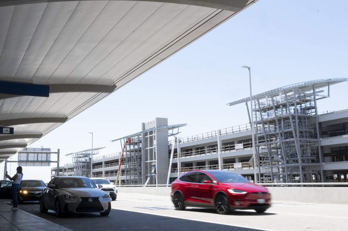 Cars arriving at the departure gates pass in front of the new parking garage currently under construction at Sacramento International Airport on Wednesday, June 17, 2026. Parking rates will increase when the six-story parking garage opens in November, before Thanksgiving, according to a Sacramento County Department of Airports spokesperson.
