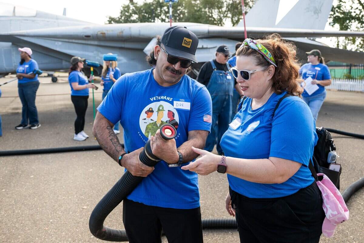 Dre Hernandez, left, learns how to use a fire hose to wash aircraft at the Aerospace Museum of California in Sacramento on Thursday.