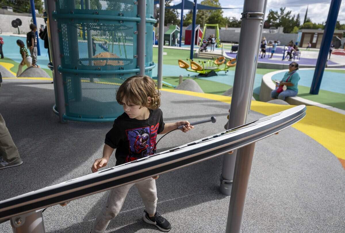 Revan Jelks plays the xylophone at Empowerment Park, a socially inclusive and sensory-integrated playground on Bell Street in Arden Arcade, on Wednesday.
