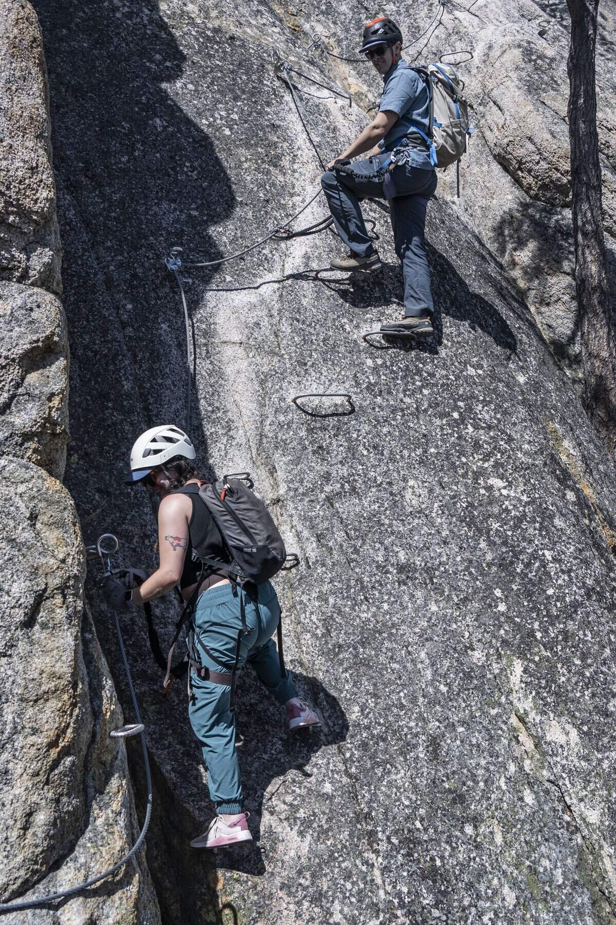 Tim Mincey, a mountain guide at Alpenglow Expeditions, keeps an eye on Sacramento Bee writer Camila Pedrosa during a tour of the Tahoe Via Ferrata at Palisades on Tuesday, Sept. 1, 2026.