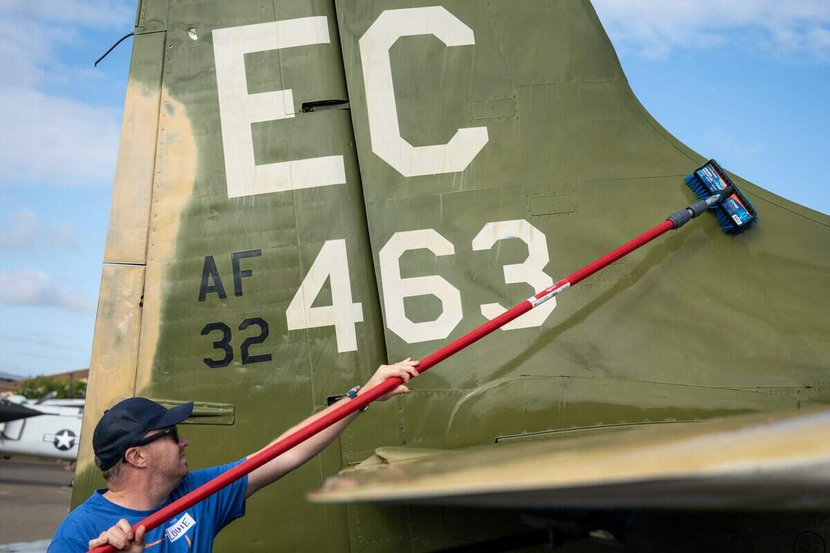 A volunteer washes an aircraft on exhibit at the Aerospace Museum of California in Sacramento on Thursday.