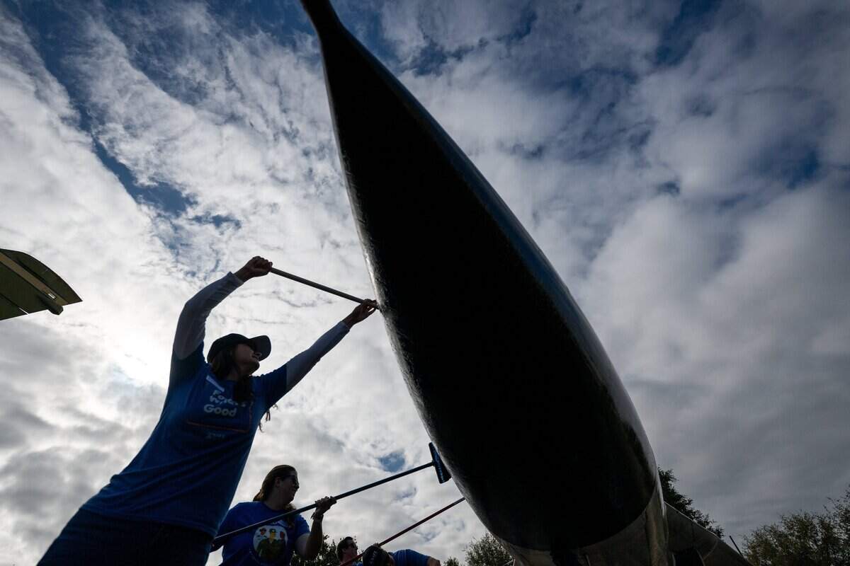 Volunteers wash an airplane at the Aerospace Museum of California in Sacramento on Thursday.
