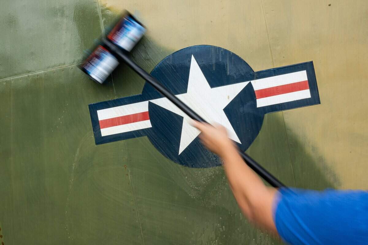 A volunteer washes an aircraft at the Aerospace Museum of California in Sacramento on Thursday.