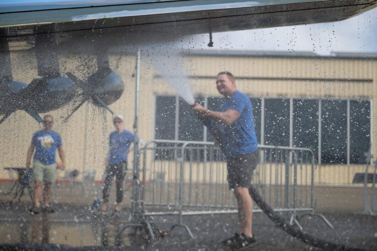 SAFE Credit Union volunteer James Kline washes an aircraft at the Aerospace Museum of California in Sacramento on Thursday.