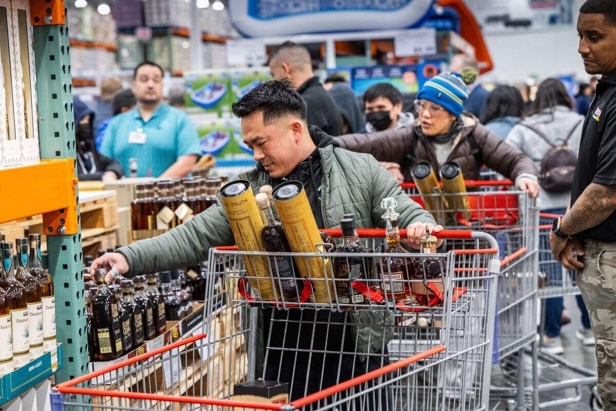 Barry Thepvong, of Fresno, looks at whisky bottles during the grand opening of the Natomas Costco store on Thursday, March 14, 2024.