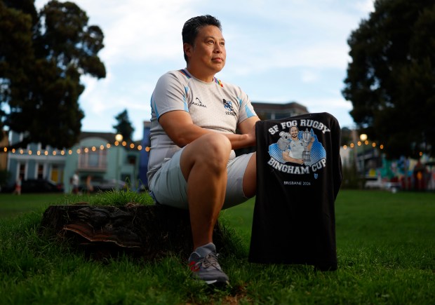 Dany Samreth, head coach of the San Francisco Fog Rugby Football Club, a gay-inclusive rugby team, poses for a photograph while holding a "Bingham Cup" t-shirt, in reference to Mark Bingham, at Precita Park in San Francisco, Calif., on Wednesday, Sept. 9, 2026. (Nhat V. Meyer/Bay Area News Group)