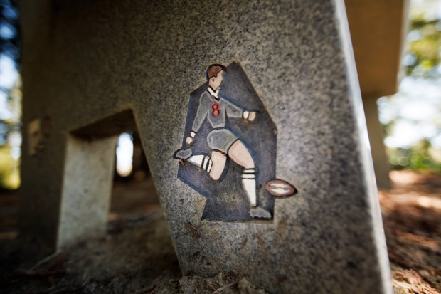 A detail on a memorial bench for Mark Bingham shows an illustration of him in a rugby uniform, pictured in Redwood Estates near Los Gatos, Calif., on Sept. 10, 2026. Bingham was among the brave passengers who stormed the cockpit of hijacked United Airlines Flight 93 to wrest control from the hijackers during the 9/11 attacks in 2001. (Dai Sugano/Bay Area News Group)