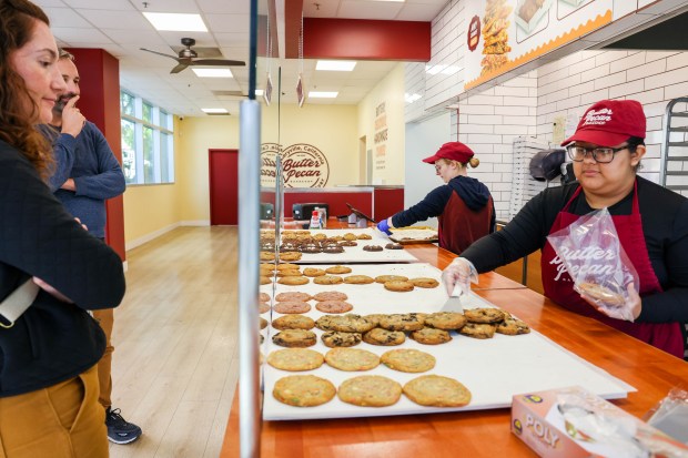 Crew member Aimee Martinez, right, takes orders from customers as Amber Hughes puts out a variety of fresh cookies just baked at Butter Pecan Bakeshop in Emeryville. (Ray Chavez/Bay Area News Group)