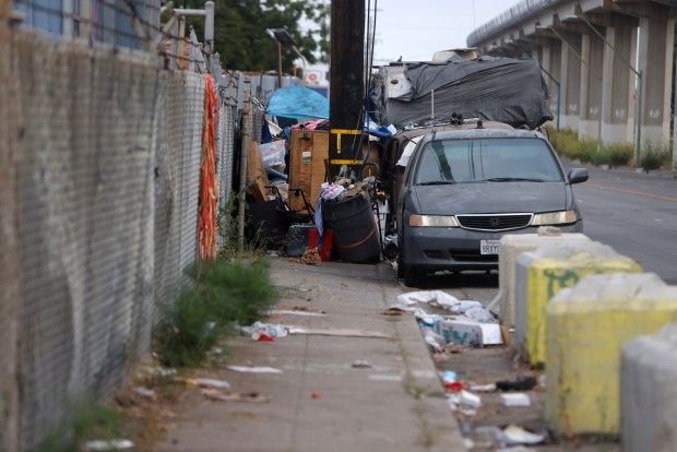 The sidewalk along San Leandro Street is blocked by a homeless encampment near Seminary Avenue on Thursday, Aug. 15, 2024, in Oakland, Calif. (Aric Crabb/Bay Area News Group)