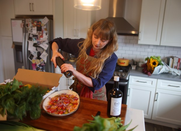 Ukrainian-born chef Anna Voloshyna, author of "Ukraïne: Recipes and Stories From Kyiv to the Black Sea," prepares a summer tomato salad with sour cream dressing in her Oakland kitchen on Sunday, Aug. 30, 2026. (Aric Crabb/Bay Area News Group)