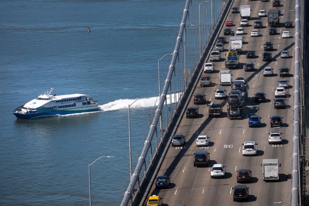 A San Francisco Bay Ferry cruises under the rush-hour traffic on the San Francisco Bay Bridge on Thursday, July 8, 2021. (Karl Mondon/Bay Area News Group)