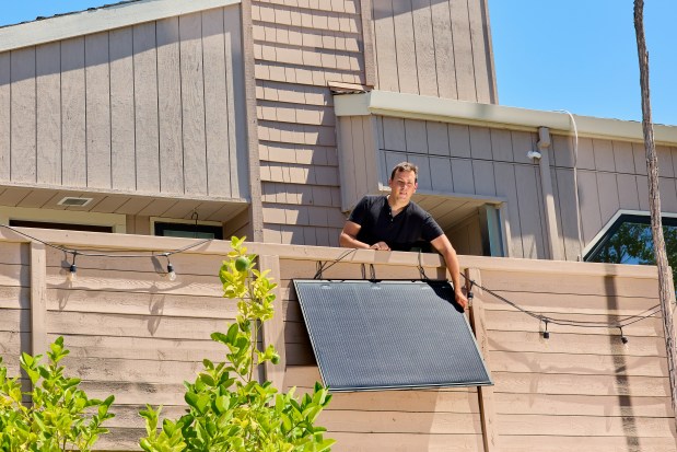 Alex Ottoboni shows a solar panel that he says saves him about $5 to $7 a month, on the balcony of his condo in Sunnyvale, Calif. on July 24, 2026. California lawmakers passed SB 868, which would legalize small-scale portable "balcony solar" systems that plug into standard 120V household outlets and exempt them from utility permitting rules. (Poppy Lynch/The New York Times)